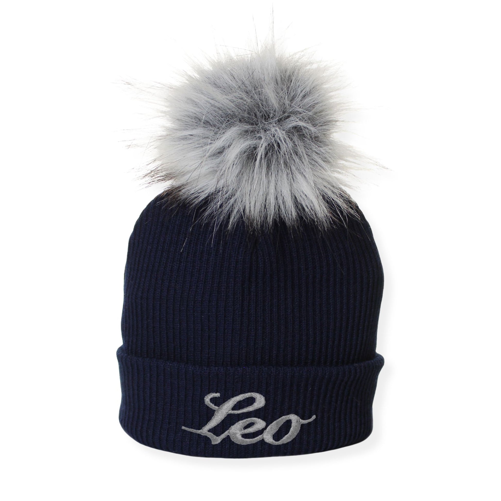 Navy blue beanie with gray fur pom-pom and 'Leo' embroidery on a white background