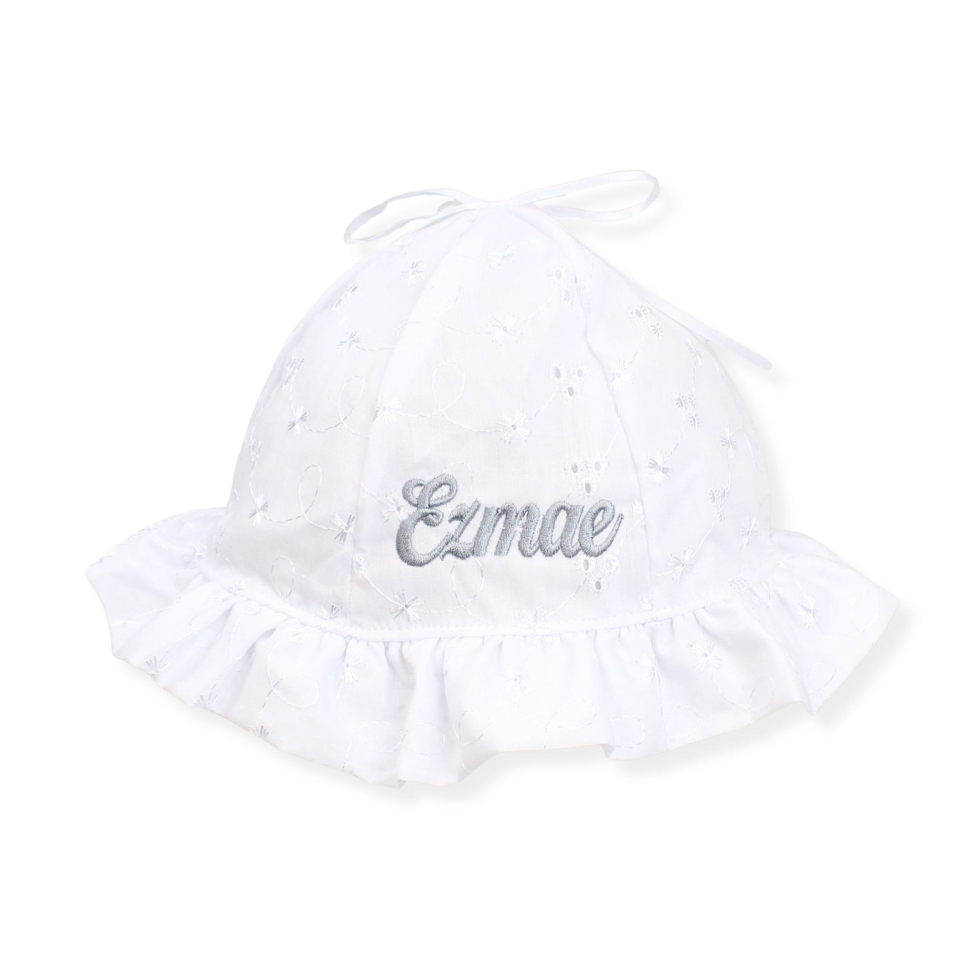 White baby hat with 'Ezmae' embroidery on a white background
