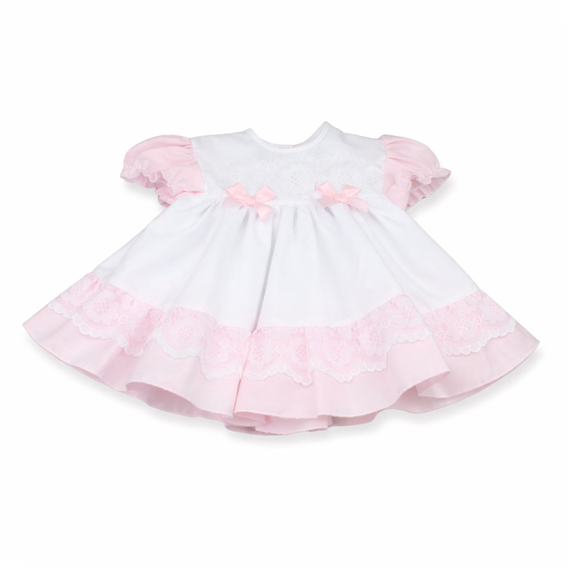 White dress with pink ruffled sleeves and hem on a white background