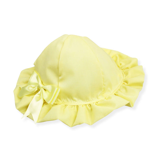Yellow baby bonnet with a bow on a white background