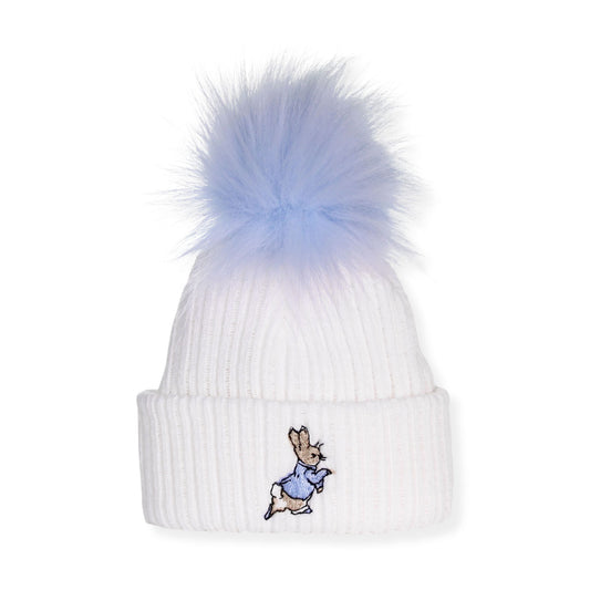 White beanie with a blue pom-pom and embroidered bunny design on a white background