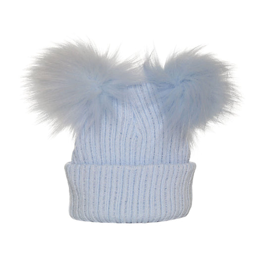 Light blue knit beanie with two large fur pom-poms on a white background