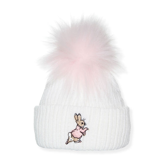 White beanie with pink pom-pom and embroidered rabbit design on a white background
