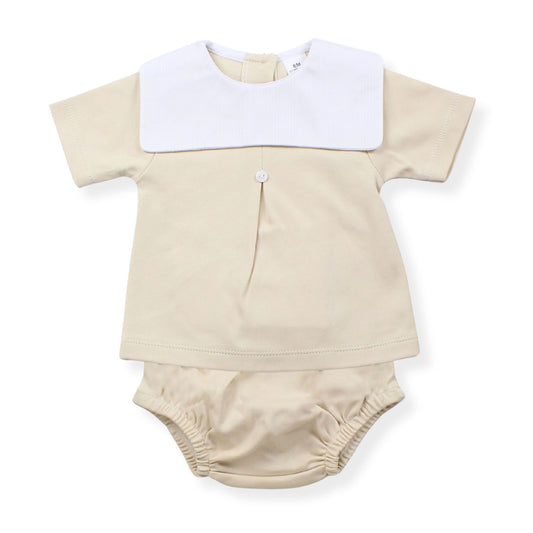 Beige baby outfit with white collar on a white background