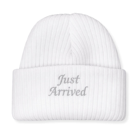 White beanie with 'Just Arrived' text on a white background