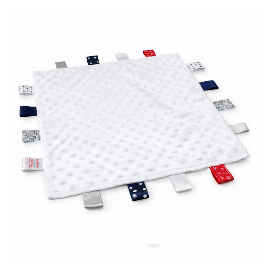 White textured blanket with colorful tags on a white background