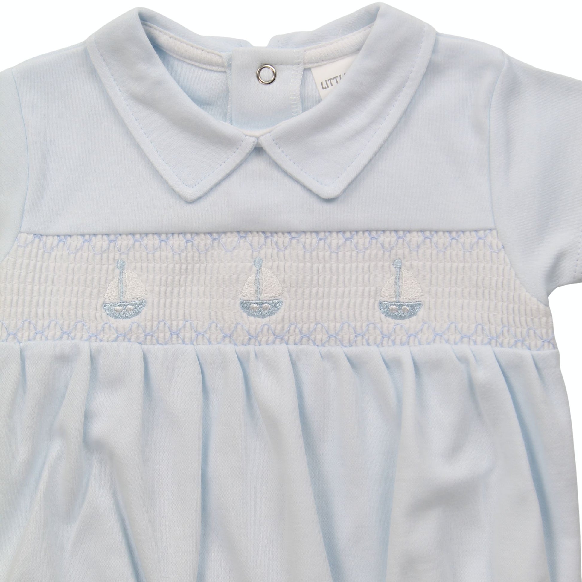 Light blue baby outfit with smocked details on a white background