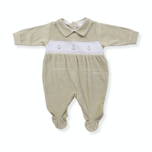 Beige baby sleepsuit with white trim on a white background