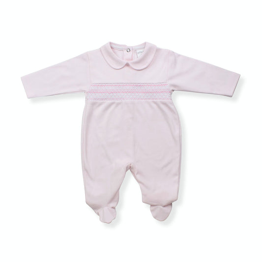 Pink baby onesie with smocked details on a white background