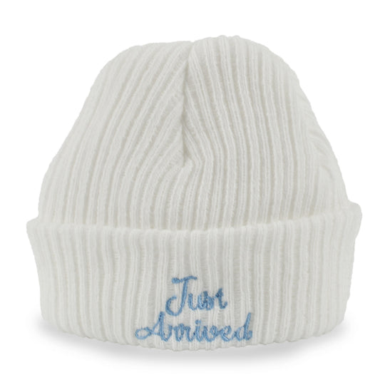 White knit baby beanie with 'Just Arrived' embroidery on a white background