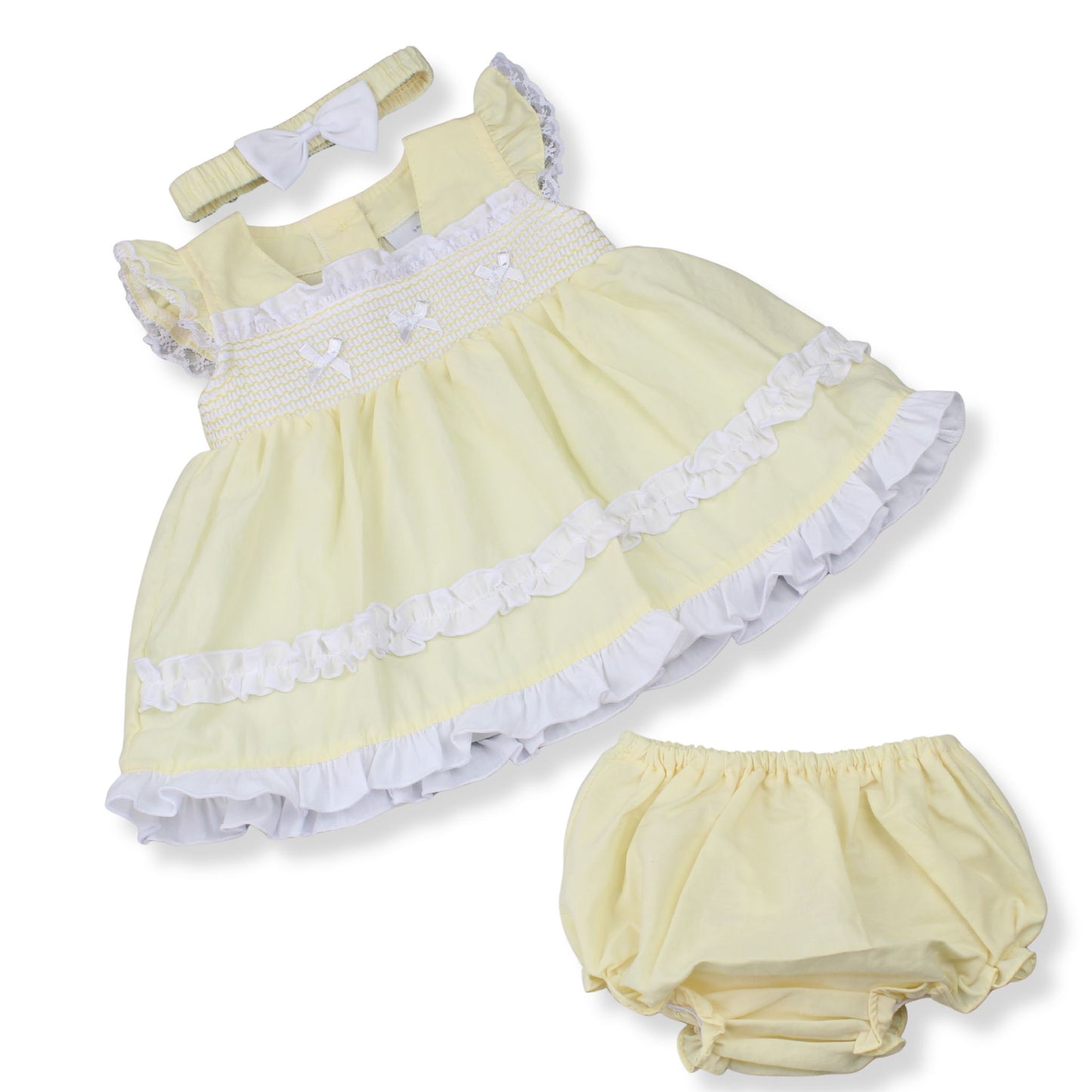 Yellow baby dress with white trim and matching bloomers on a white background