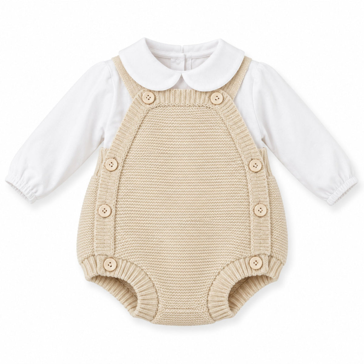 A baby's two-piece knit romper set featuring a beige knitted overall-style bodysuit with a white long-sleeve shirt underneath, complete with a white Peter Pan collar and matching wooden buttons.