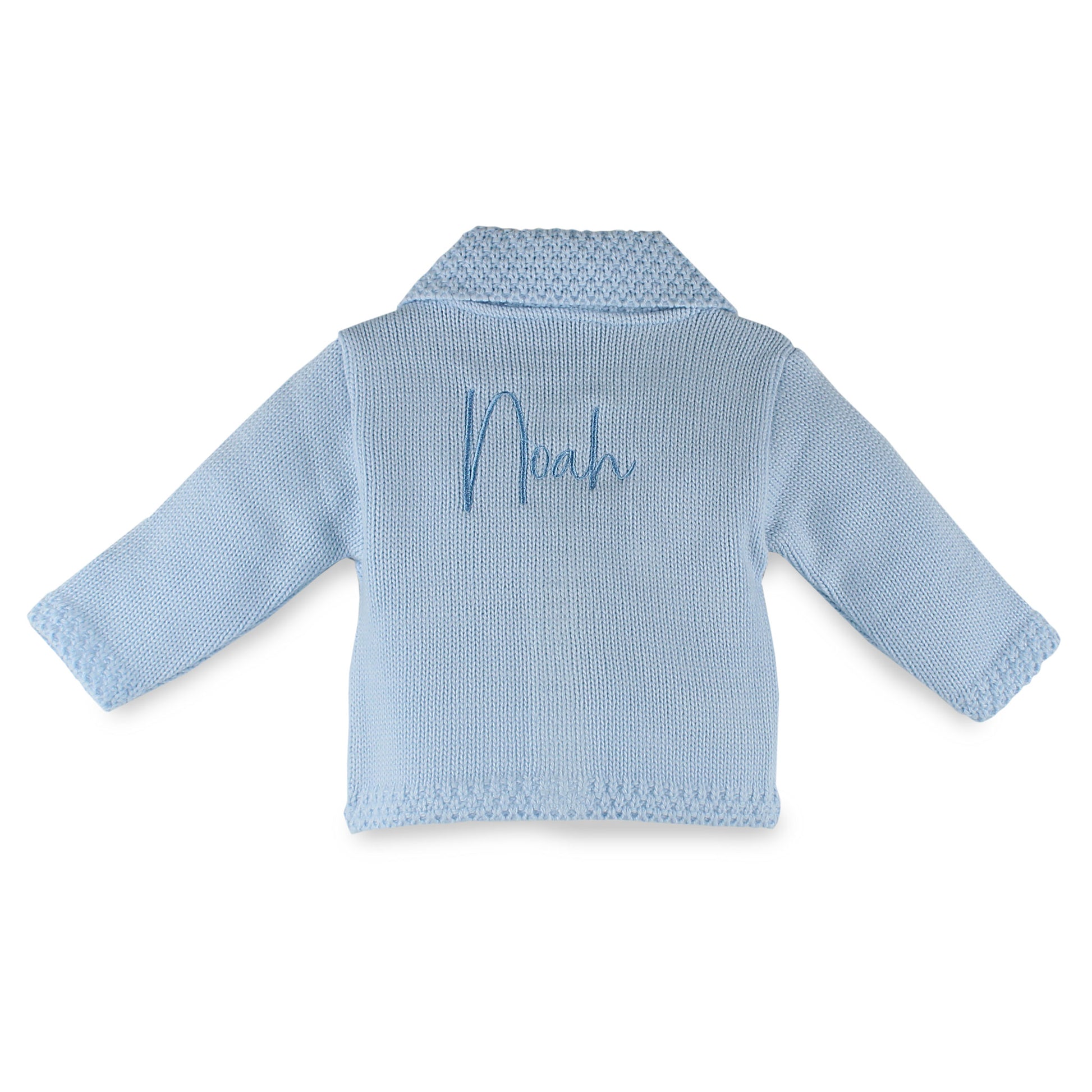 Personalised blue knitted baby cardigan by Dandelion with embroidered name on the back, traditional collar detail and button fastening. Made in Portugal. Available from newborn to 6-12 months.