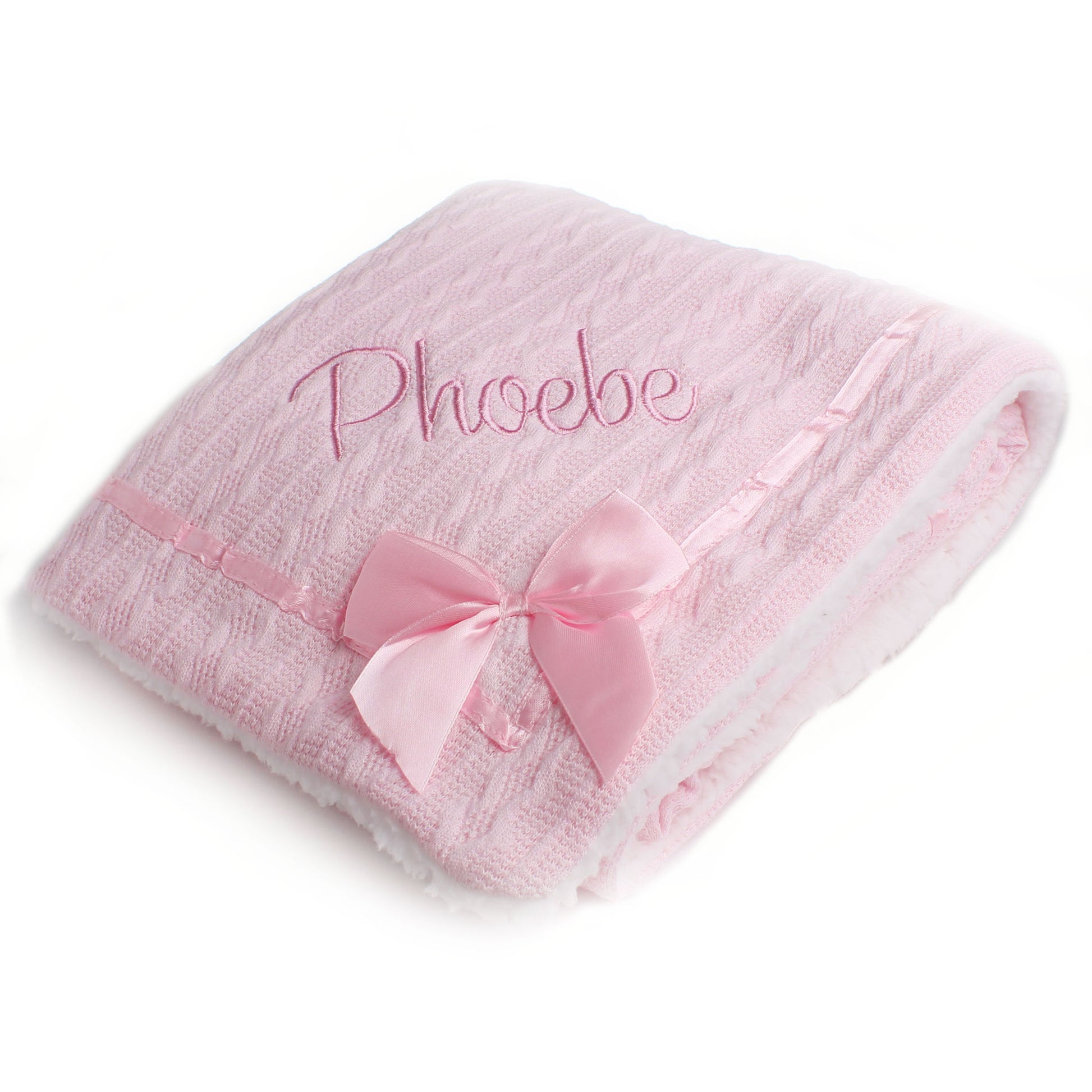 Pink baby blanket with a bow and embroidered name on a white background