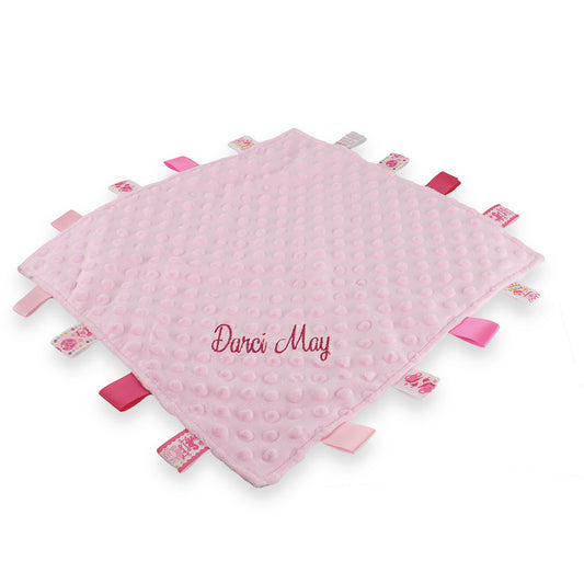 Pink baby personalised taggy with 'Darci May' embroidery on a white background