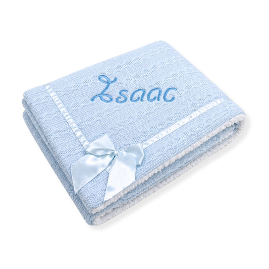 Blue baby blanket with embroidered name and bow on a white background