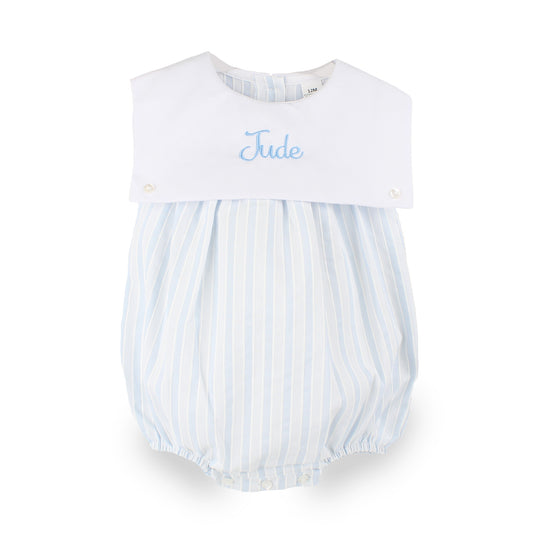 Personalised baby boys blue and white striped bubble romper embroidered with the name Jude on the white front panel.
