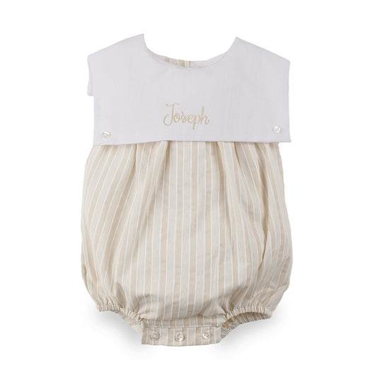 A baby bubble romper with a white collar featuring the name 'Joseph' embroidered in gold, and a cream and beige vertically striped body.