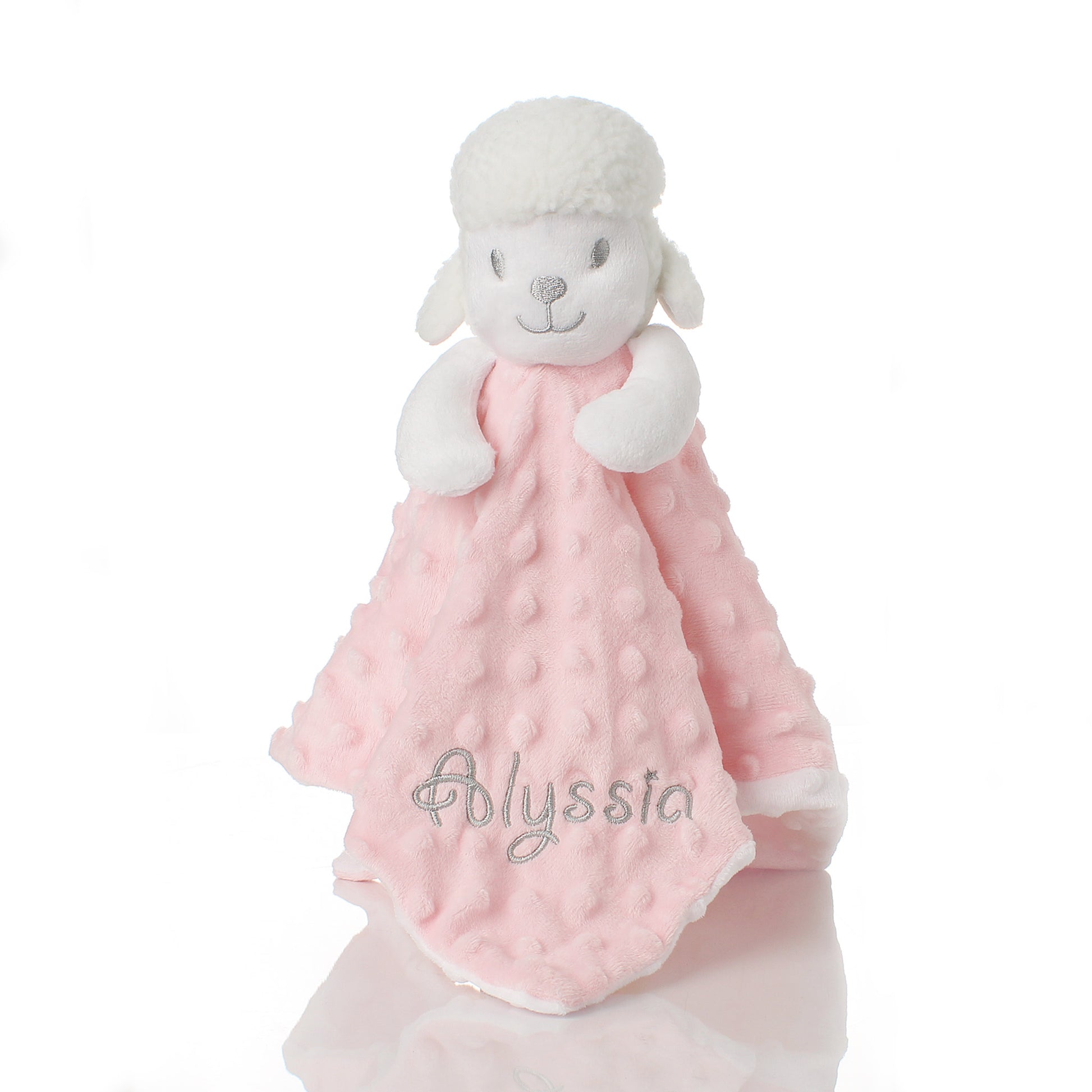 A soft plush sheep security blanket with a white fluffy body and a pink minky dot blanket, featuring the brand name 'Polyssia' embroidered on the front, set against a plain white background.