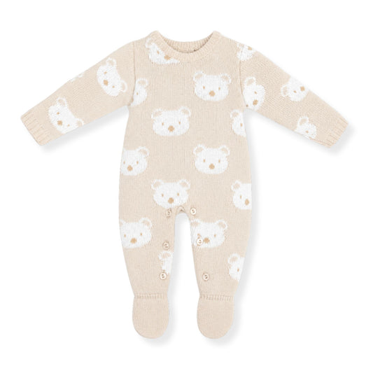 Beige baby onesie with white bear pattern on a white background