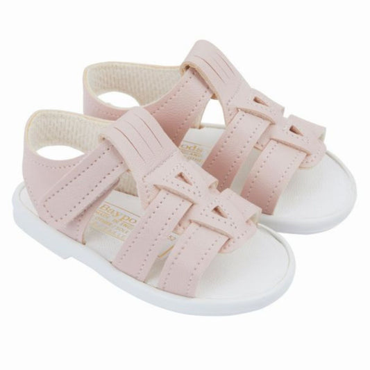 Pair of pink sandals with white soles on a white background