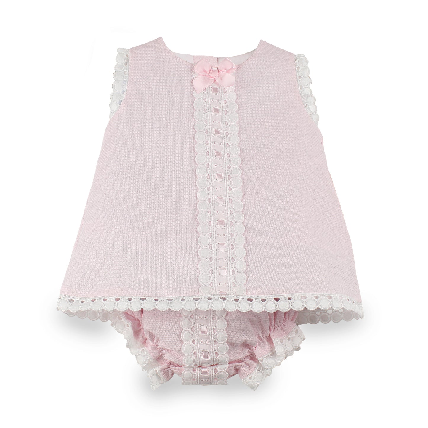 A baby girl's two-piece outfit in light pink textured fabric, featuring a sleeveless top with white scalloped lace trim and a matching pink ruffled bloomers set with lace trim, accented by a small pink bow at the neckline.