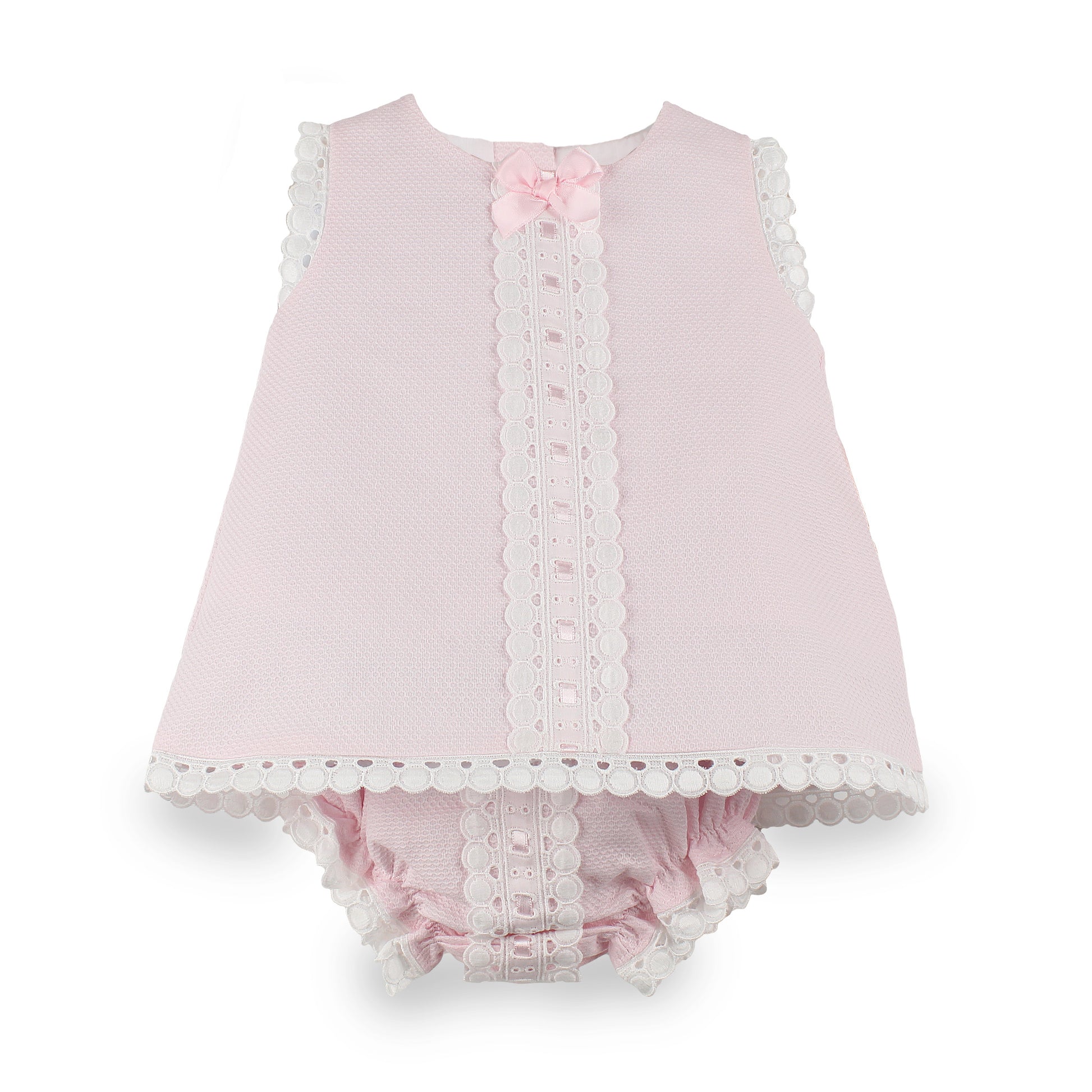 A baby girl's two-piece outfit in light pink textured fabric, featuring a sleeveless top with white scalloped lace trim and a matching pink ruffled bloomers set with lace trim, accented by a small pink bow at the neckline.