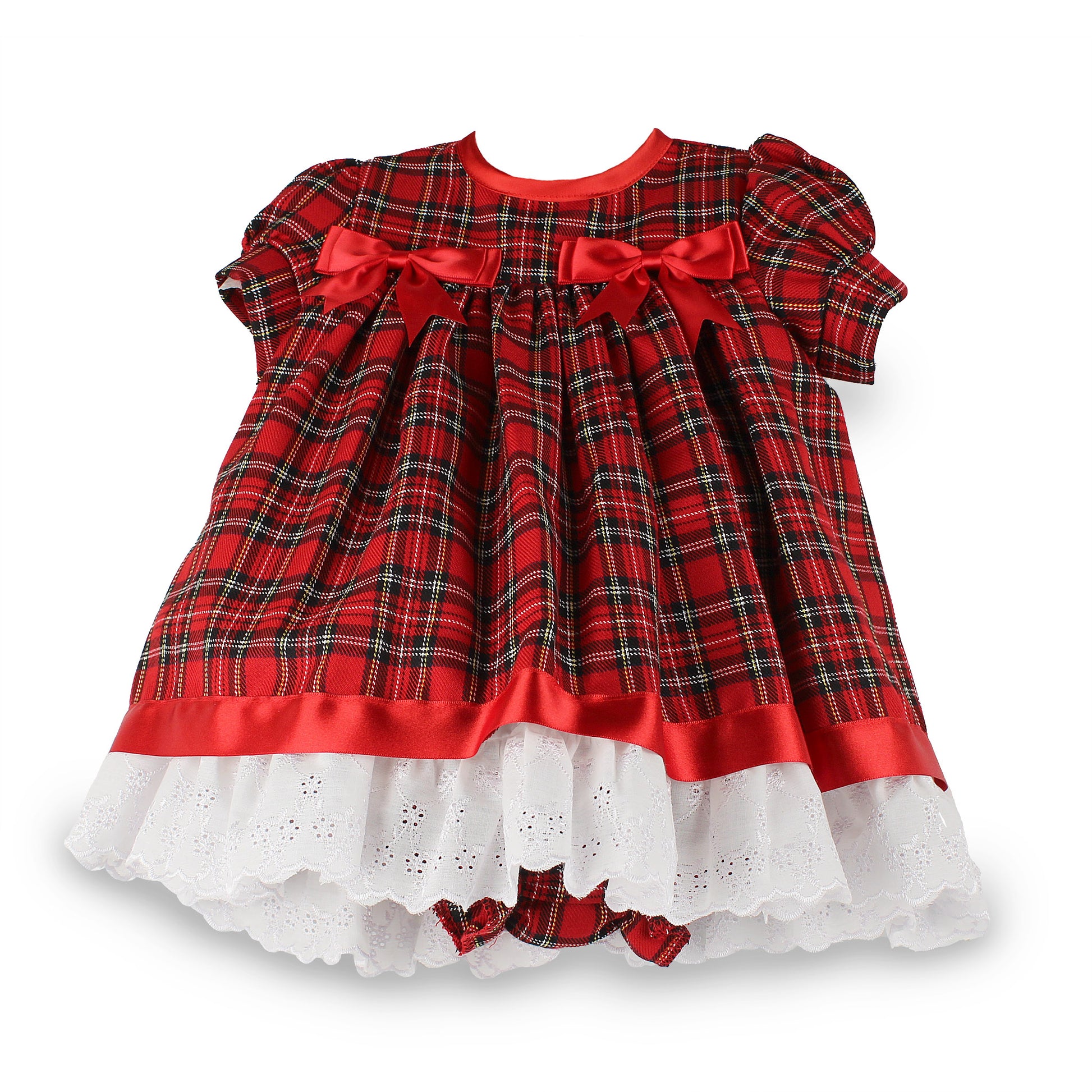A toddler girl's short-sleeve plaid dress in red tartan with black and green lines, featuring red satin bows at the chest, a red satin waistband, and a white eyelet ruffled hem.