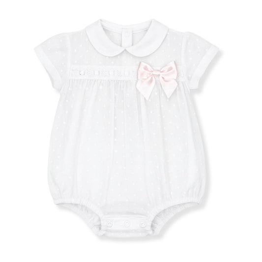 White baby romper with a pink bow on a white background