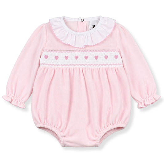 Pink baby romper with heart patterns on a white background