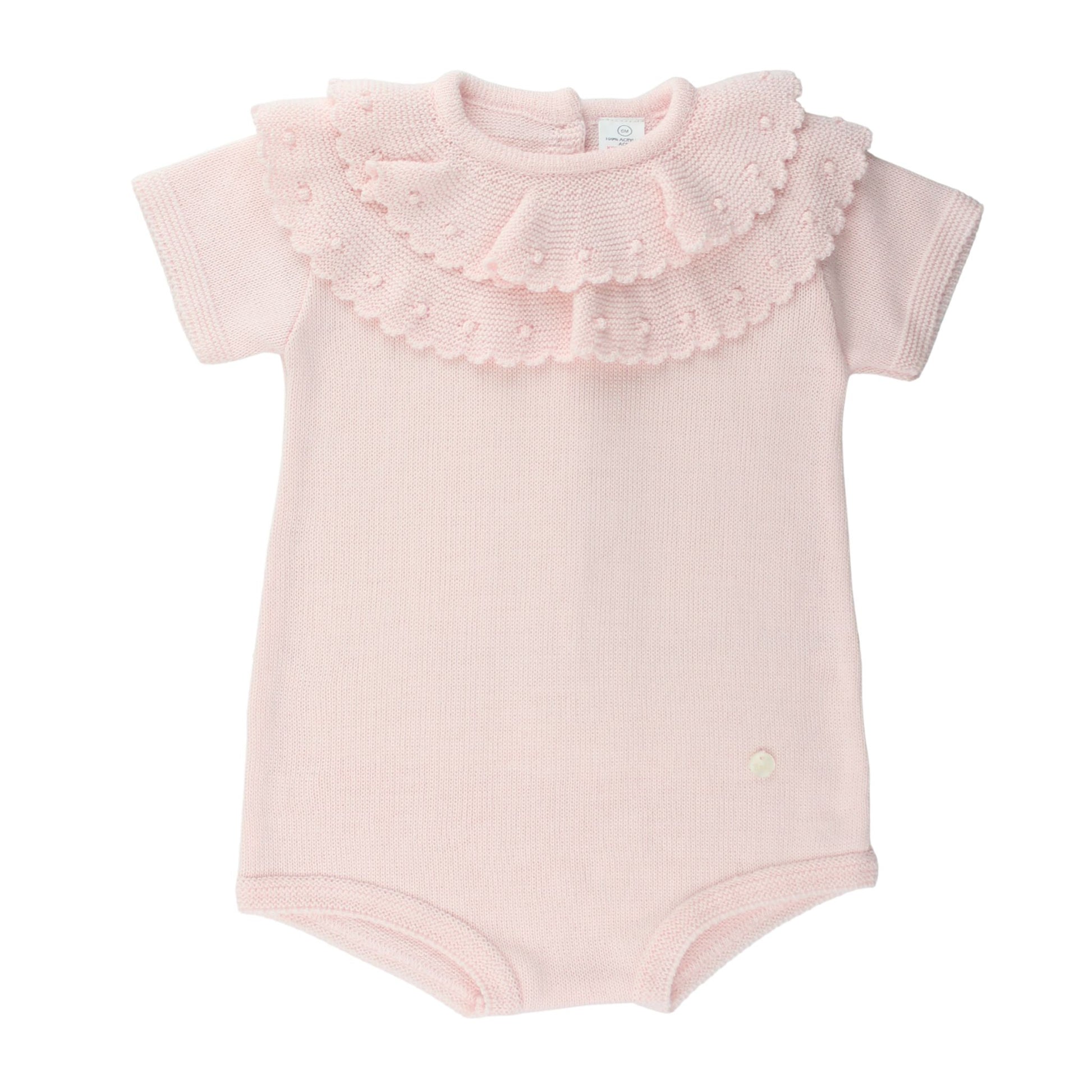 Pink baby knitted romper with ruffled collar on a white background