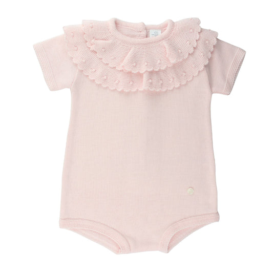 Pink baby knitted romper with ruffled collar on a white background