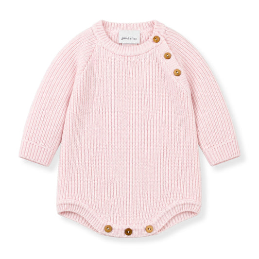 Pink baby romper with button details on a white background