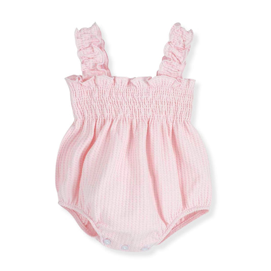 Pink baby romper with ruffled straps on a white background