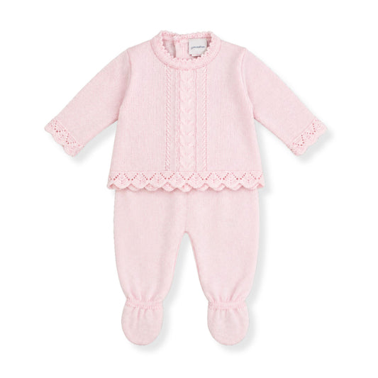 Pink baby knitted outfit with lace knit details on a white background