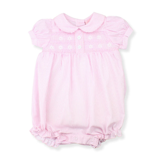 Pink baby romper with ruffled details on a white background