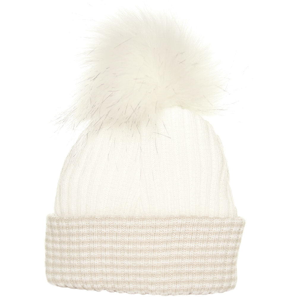 White knit beanie with pom-pom on a white background