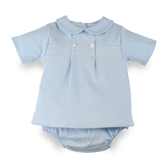 A light blue baby outfit set featuring a short-sleeve top with a Peter Pan collar, smocked chest panel, and three white buttons, paired with matching smocked pants, shown on a plain white background.