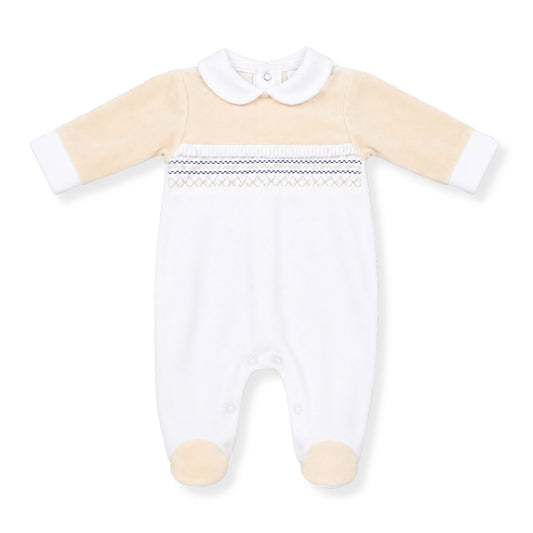Baby boys white and cream velour sleepsuit with Peter Pan collar, smocked chest panel with blue stitching detail, and footed design on a white background