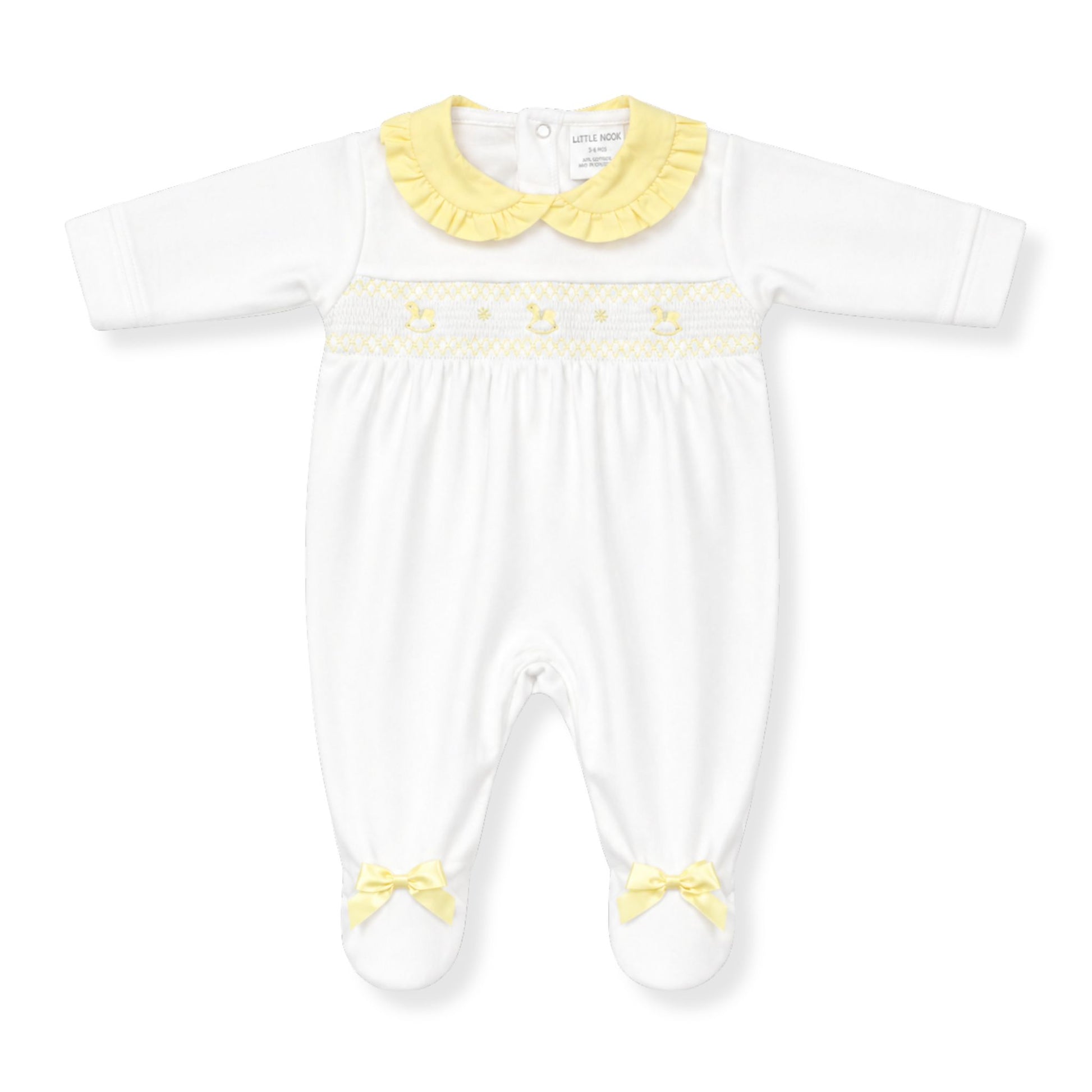 White baby babygrow with yellow trim and accents on a white background