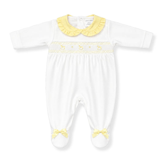 White baby babygrow with yellow trim and accents on a white background