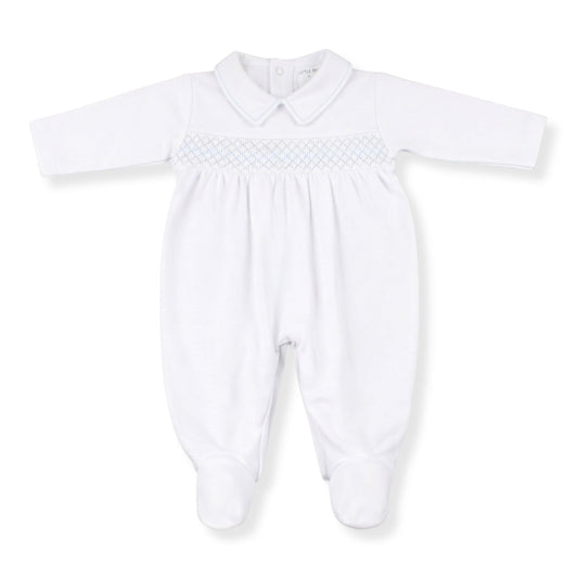 White baby grow with smocked details on a white 