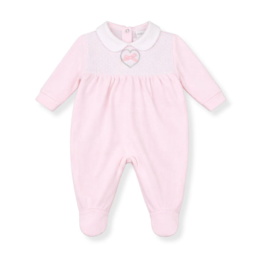 Pink baby onesie with a heart design on a white background