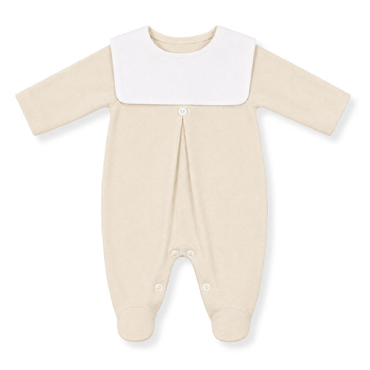 Beige baby sleepsuit / babygrow with a white collar on a white background