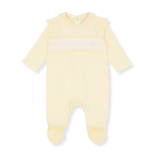 Yellow baby sleepsuit with white stripes on a white background