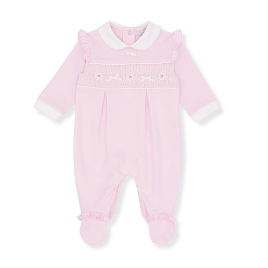 Pink baby girl babygrow sleepsuitwith white trim on a white background