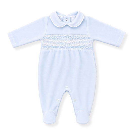 Light blue baby velour sleepsuit with smocked details on a white background