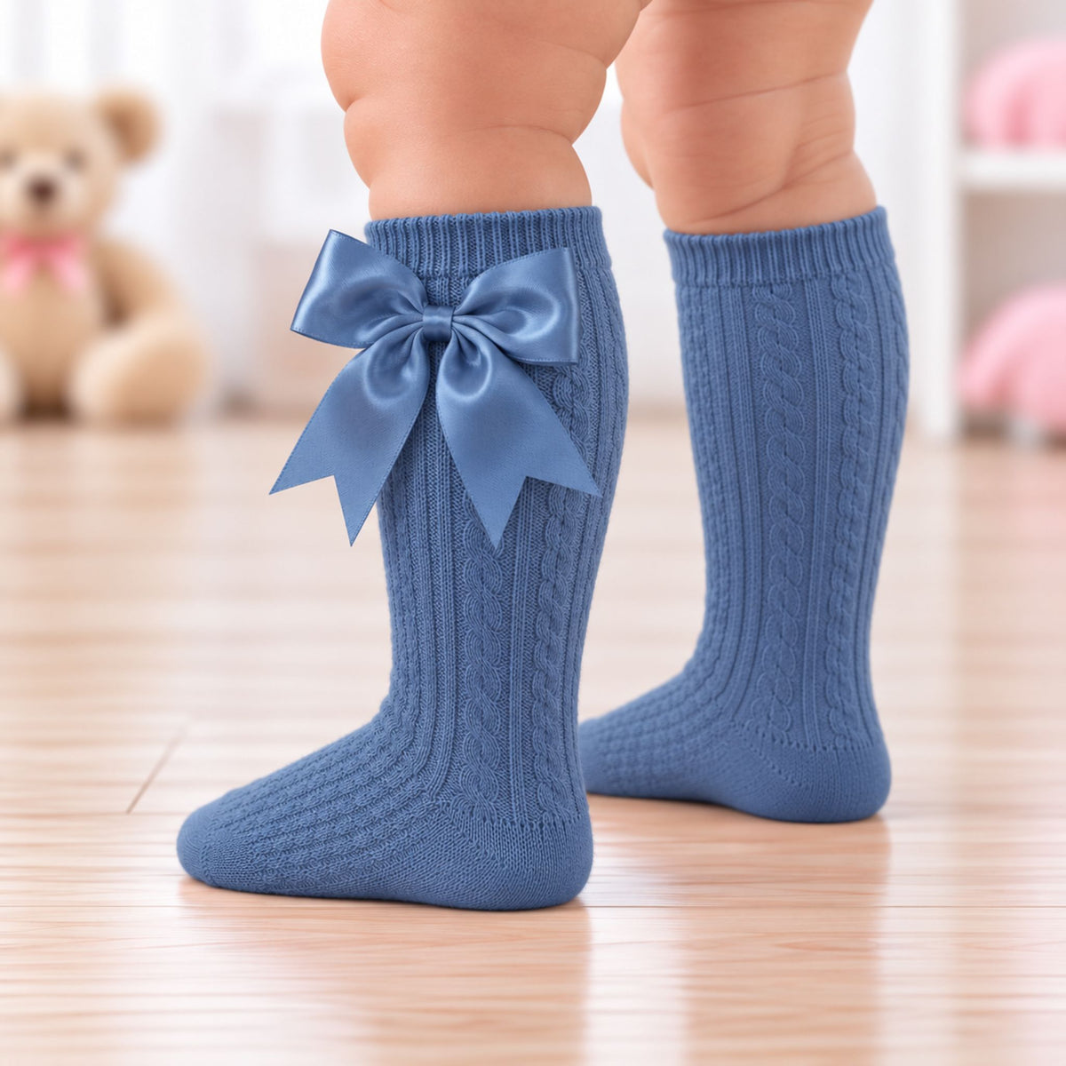 Steel blue knee high baby socks with cable knit design and satin bow