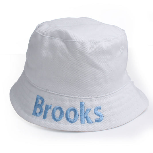 White baby personalised bucket hat with name embroidered in blue on a white background