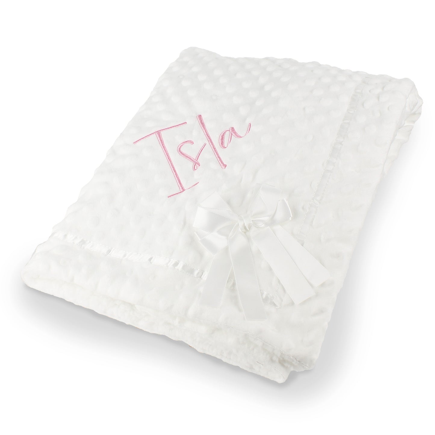 A folded  personalised white textured baby blanket with a white satin bow and pink embroidered name 'Isla', shown on a clean white background.
